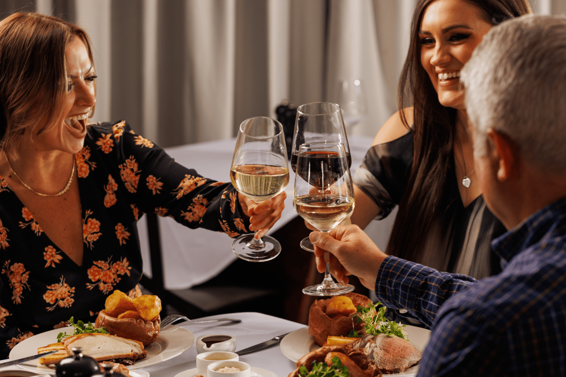 Diners at Marco Pierre White Steakhouse, celebrating with wine